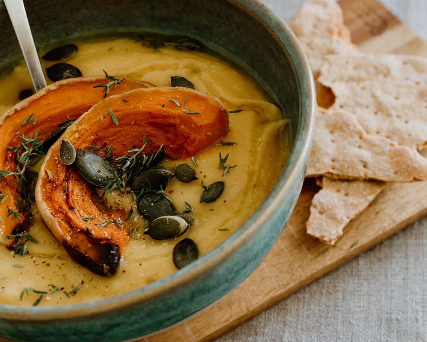 A ceramic bowl filled with delicious autumn pumpkin soup made from a favourite recipe