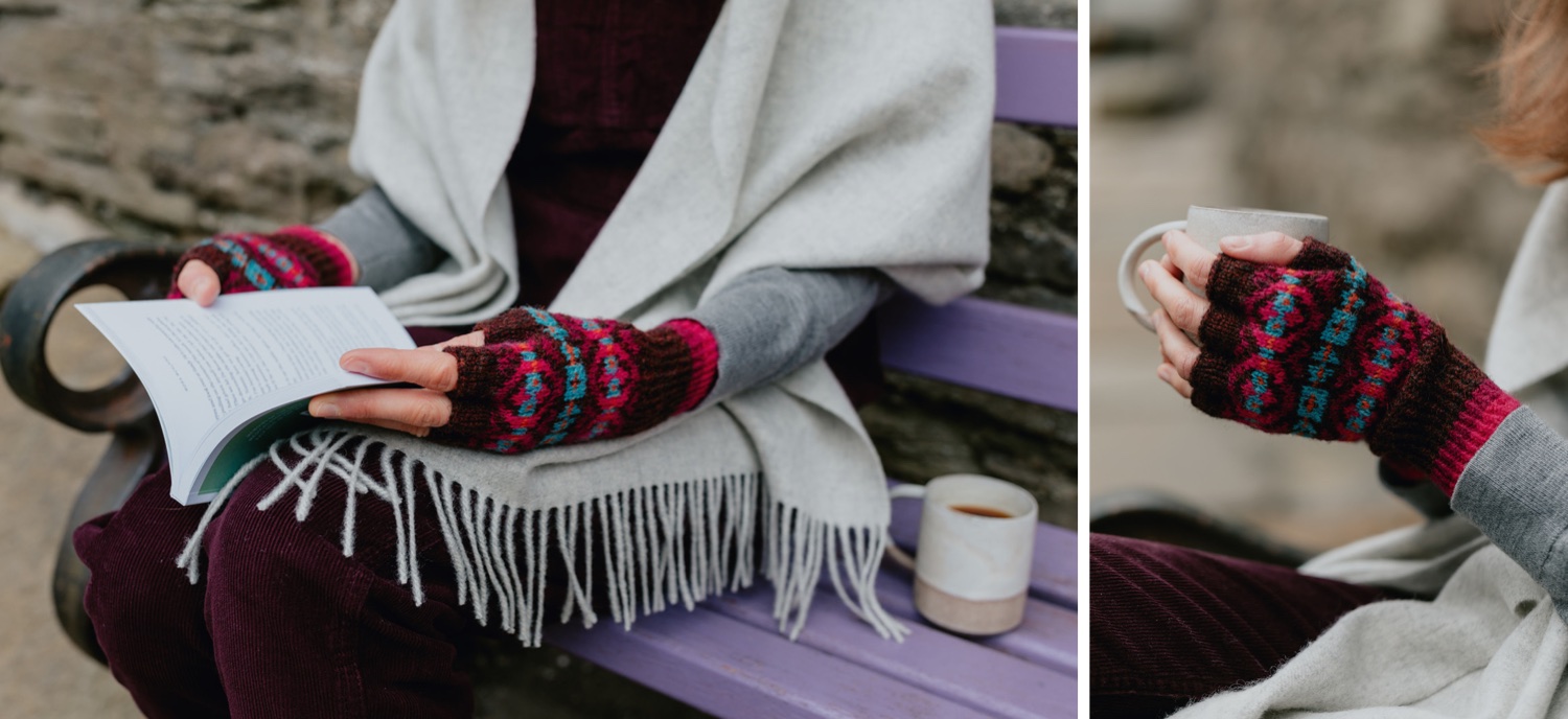 Woman wearing Fair Isle mittens in beautiful Christmas inspired colours. She is practicing the art of Hygge by mindfully reading a book and enjoying coffee