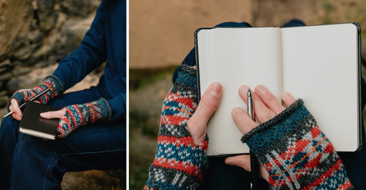 Woman journaling and holding a pen as she practices gratitude for a hygge inspired Christmas. She is wearing blue and red fair isle mittens.